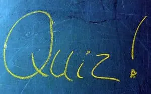 The word Quiz written on a chalkboard for a suggestibility questionnaire