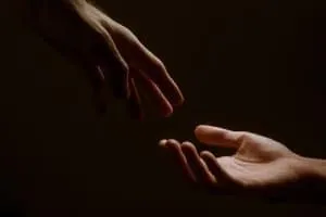 Hands reaching toward one another for support