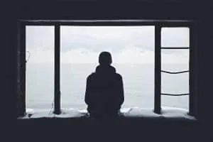 Person sitting alone, illustrating loneliness