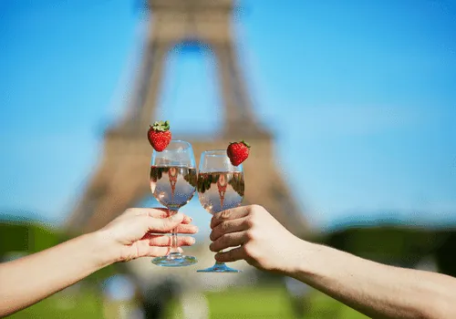 Two glasses raised in a toast on a romantic trip