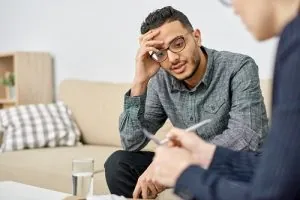 Therapist speaking with a client during a counseling session
