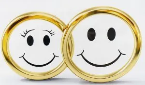 Two wedding rings with smiling faces, illustrating a decision about marriage