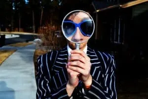 Person looking through a magnifying glass, illustrating self-examination